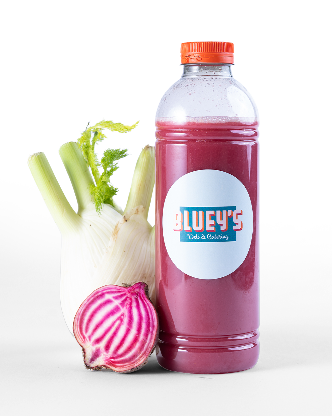 Bottle of BLUEY'S Pink Juice, freshly made with ginger, beet, and fennel. A product in the BLUEY'S Catering offering that can be delivered to your office in Amsterdam